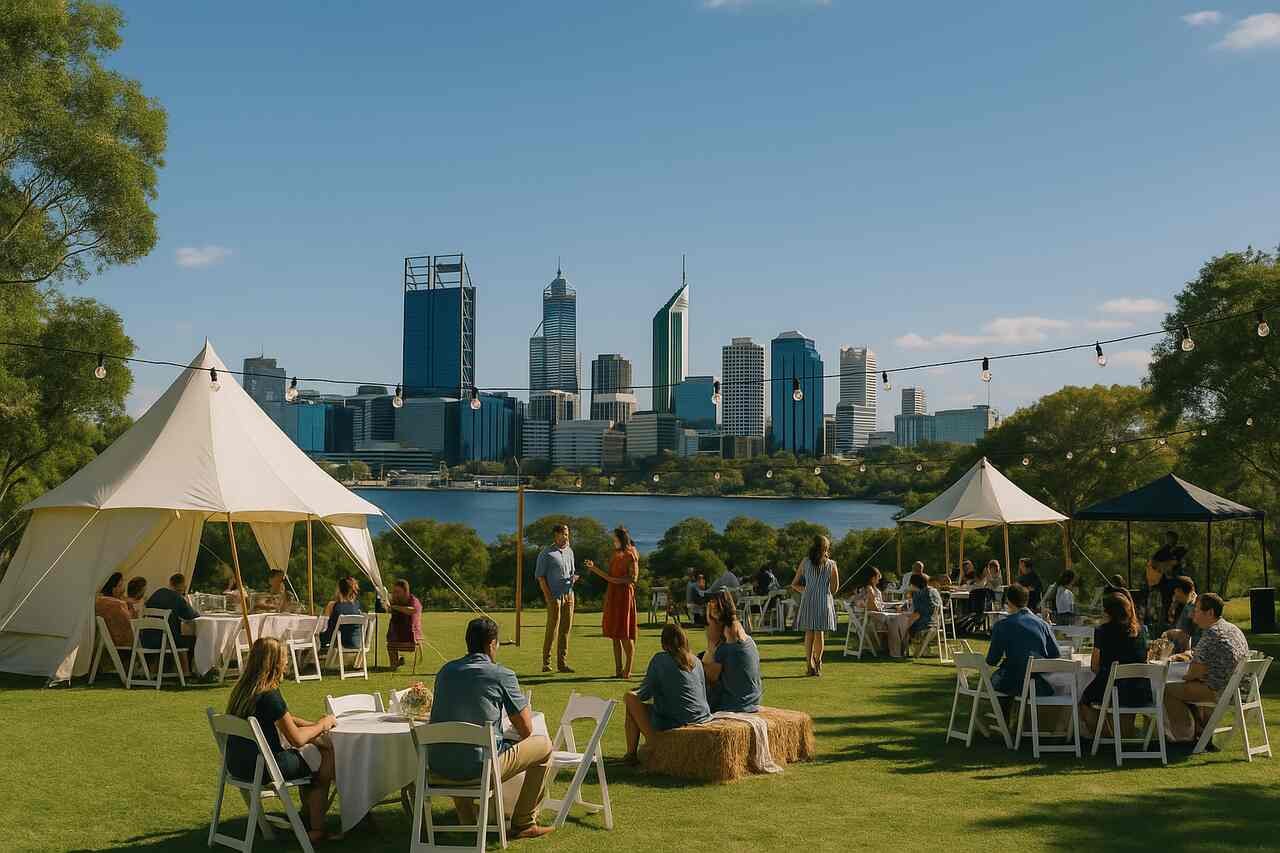 Outdoor event in Perth with city skyline, guests seated under tents, and string lights during a sunny day.