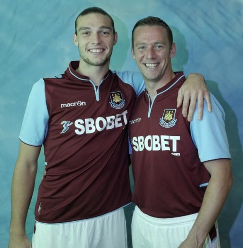 Andy Carroll and teammate smiling in West Ham United kits.