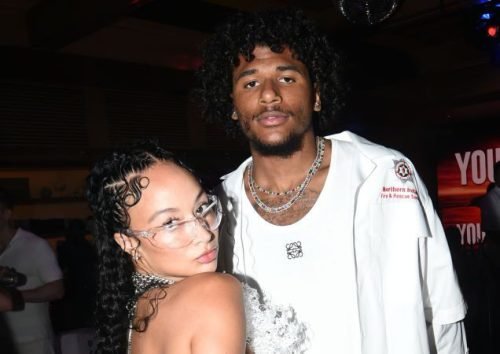 Jalen Green and Draya Michele posing together at a stylish indoor event.