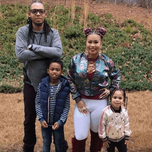 Lovely Mimi poses outdoors with her ex-husband and their two children.