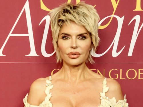 Lisa Rinna in a cream dress with short blonde hair at an awards event.
