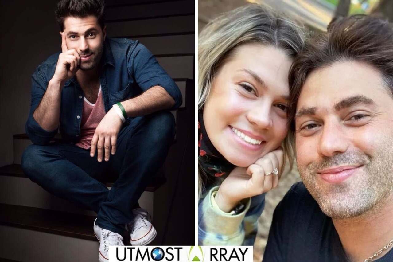 Adam Ray posing on stairs and smiling in a selfie with a woman.