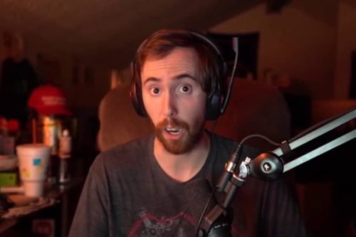 asmongold wearing a headset and speaking into a microphone during a live broadcast.