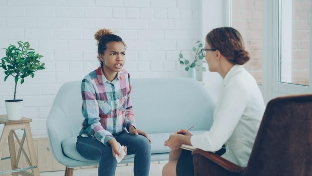 The Healing Power of Words: How Talking Enhances Mental Wellness Two women talking, symbolizing the healing power of words for mental wellness.