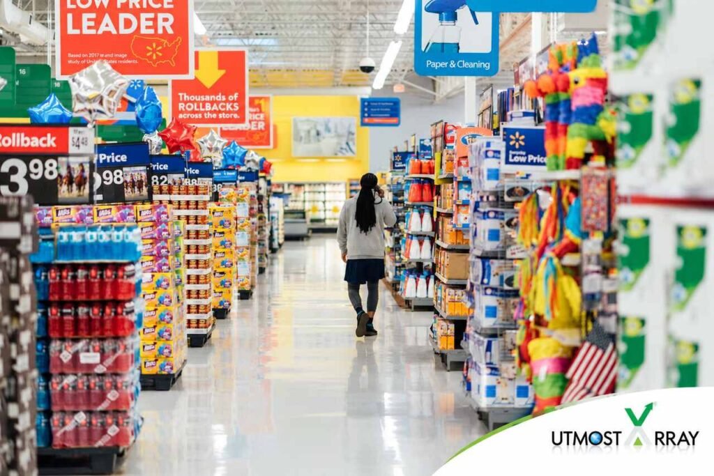 Personal Finance: Reducing Waste, Saving Money Shopper walking through a Walmart aisle with low-price signs and household products.